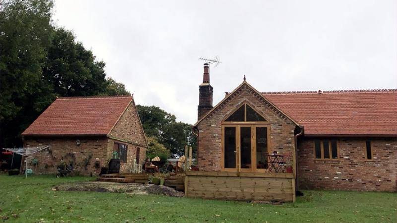New Marley tiled roof with character finial ridges on a brick property